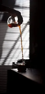 Silhouette of coffee being poured in minimalist style against a window background.