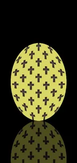 Yellow egg with black crosses on a black background wallpaper.