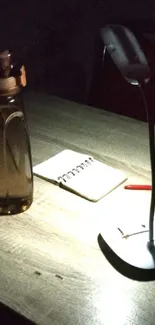 Minimalist desk with lamp and notebook under ambient light.