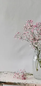 Minimalist floral mobile wallpaper with pink flowers in a glass vase.