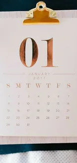 Minimalist January 2017 calendar on clipboard.