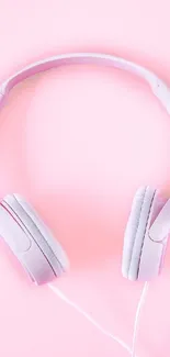 Minimalist pink headphones on soft background.