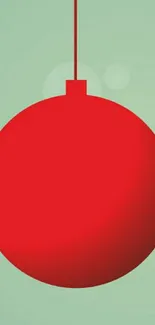 Minimalist red ornament on pastel green background.