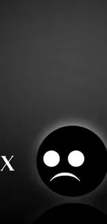 Minimalist wallpaper with a sad face emoji in black and gray tones.