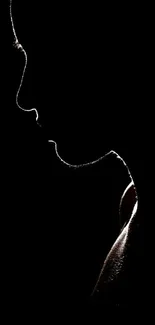 Minimalist black silhouette of a face against a dark background.