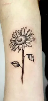 Elegant minimalist sunflower tattoo on arm.