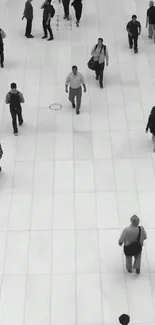 Black and white urban walkway with people in motion.