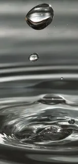 Close-up of water droplets rippling on a smooth, minimalist surface.