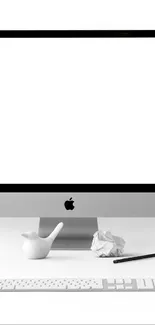 Minimalist workspace featuring a computer and white background.