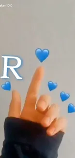 Hand reaching for blue hearts with 'R' floating above.