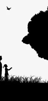 Silhouette of people and tree with birds flying above.