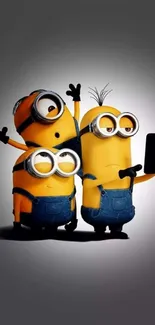 Three playful Minions taking a selfie on a mobile wallpaper.