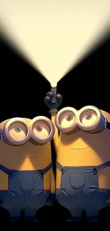 Two minions in overalls with spotlight.