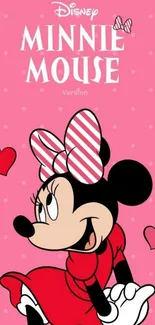 Minnie Mouse in red dress with pink hearts on a dotted pink background.