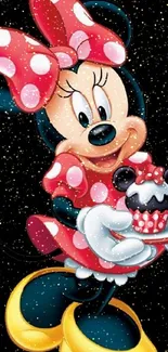 Minnie Mouse holding a cupcake on a dark background.