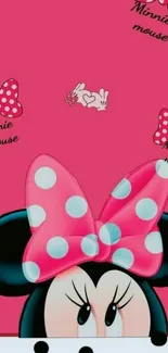 Minnie Mouse peeks over a pink polka-dotted background.