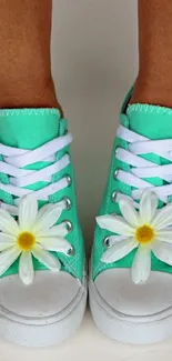 Mint green sneakers with daisies on toes.