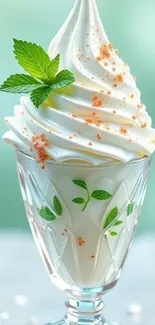 Mint garnished ice cream swirl in glass dish.