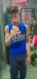 Young man taking gym mirror selfie in casual sportswear.