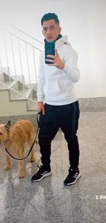 Person taking a mirror selfie with a dog on a leash.