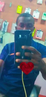 Mirror selfie with heart design on phone cover.