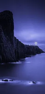 Misty nightscape with cliffs and a glowing lighthouse in deep blue hues.