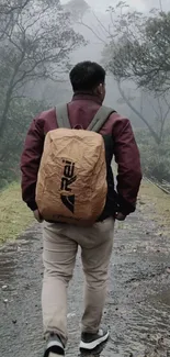 Lone hiker walking down a misty forest path with a brown backpack.