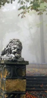 Lion statue in a misty forest landscape with autumn leaves.