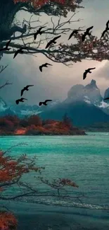 Misty mountain lake with birds flying through autumn trees.