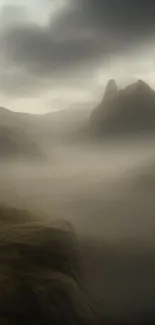 Misty mountain landscape with fog and dramatic clouds.