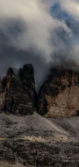 Misty mountain peaks under cloudy sky, perfect for a serene wallpaper.