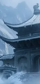 Snow-covered temple in misty mountains.