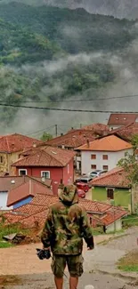 Misty mountain village with red roofs and lush greenery.