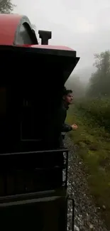 Misty train view with lush greenery background.