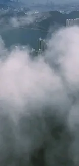 Misty urban skyline with towering buildings and clouds.