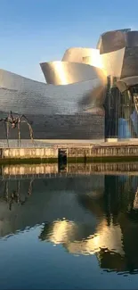 Contemporary building with reflective water view at sunset.