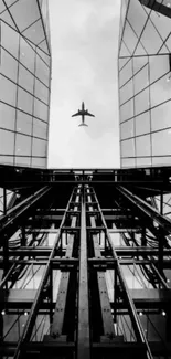 Black and white wallpaper featuring modern glass buildings and an airplane.