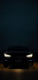 Sleek modern car at night with glowing headlights in dark setting.