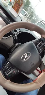 Close-up of a modern car steering wheel in a stylish vehicle interior.