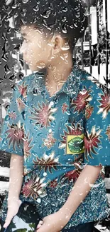 Young boy in a teal floral shirt holds a phone, standing in front of an urban background.