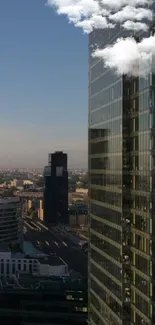 Reflection of modern skyscrapers with blue sky and clouds.