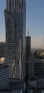 A striking modern skyscraper in a cityscape under a clear blue sky.