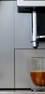 Modern coffee maker with espresso shot in a glass cup.