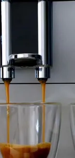 Close-up of a modern espresso machine pouring coffee into glasses.