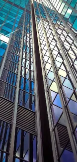 Upward view of a modern skyscraper reflecting the sky.