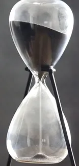 Sleek and modern hourglass against a gray background.