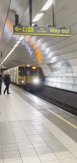 Modern metro station with a train arriving and waiting passengers.