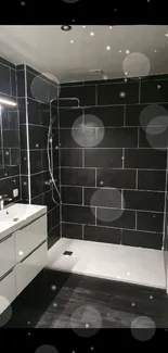 Sleek modern bathroom with black tiles and walk-in shower.