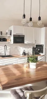 Modern minimalist kitchen with white cabinets and wooden countertop decor.