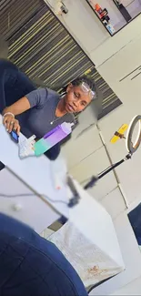 A person in a modern salon with reflective surfaces and stylish decor.